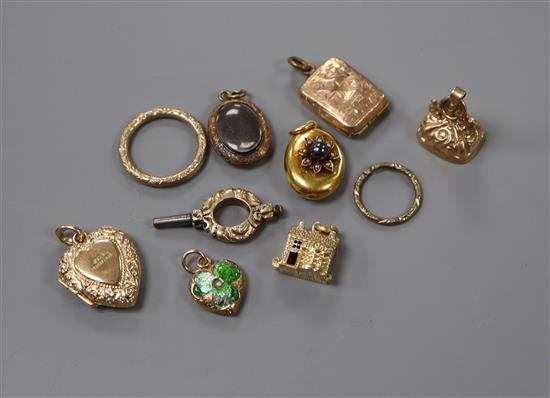 Ten assorted yellow metal charms, including enamel, and split pearl and hematite.